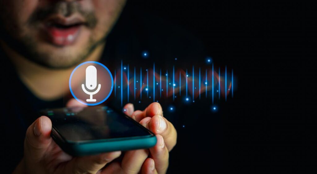Close up of man holding in hand smart phone talking with digital assistant or friend